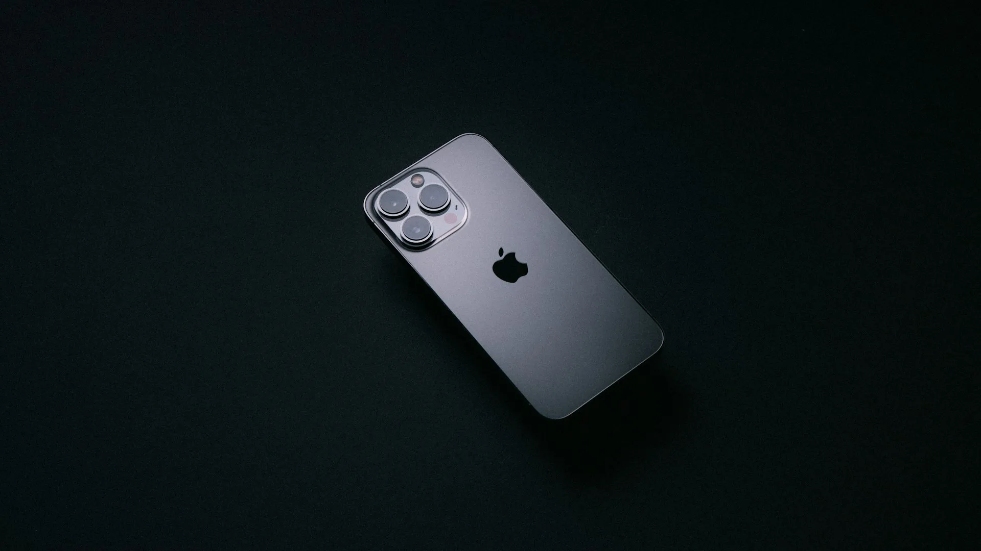 Silver iPhone on a dark table, ready for setup