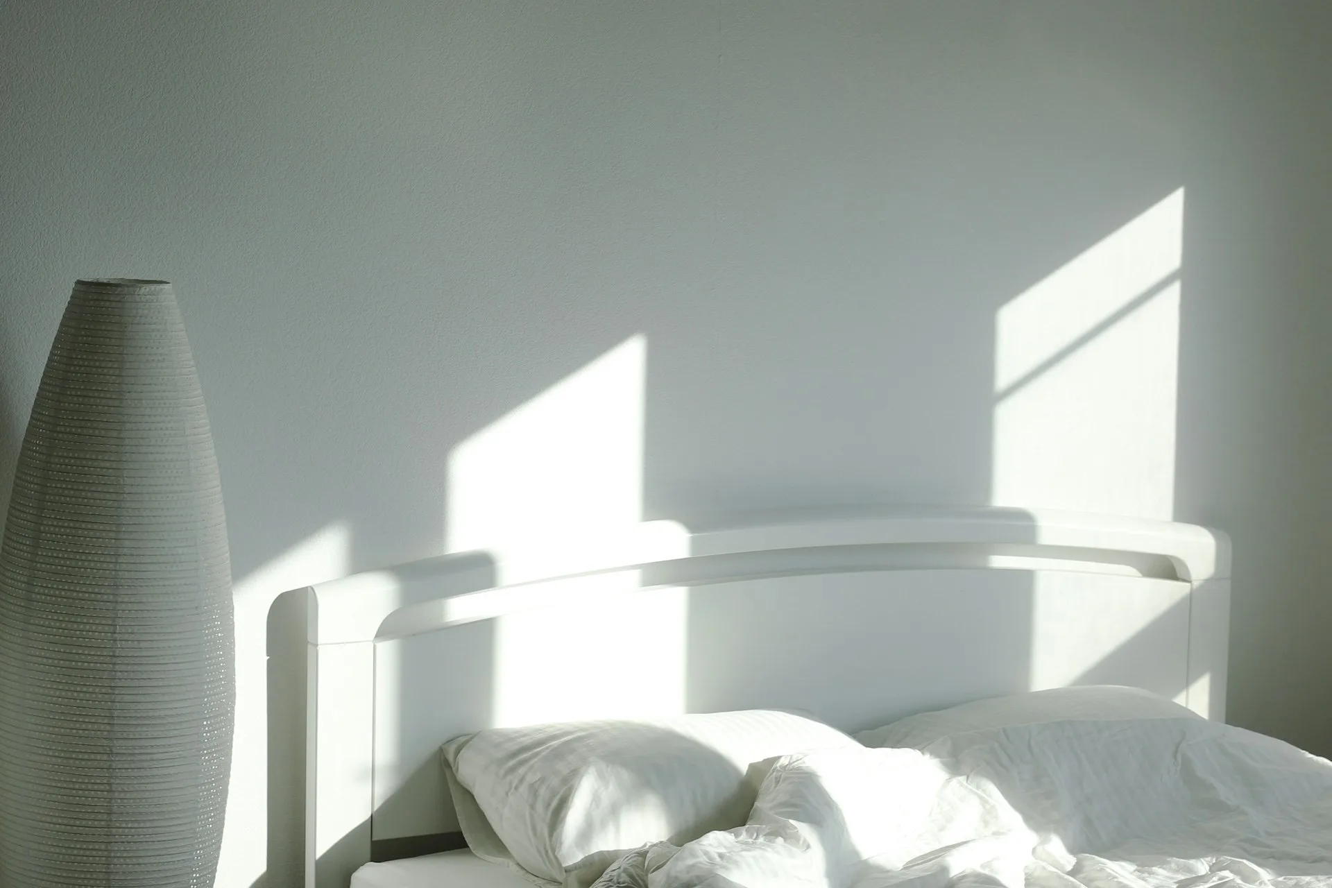 Bright morning sunlight streaming through a bedroom window