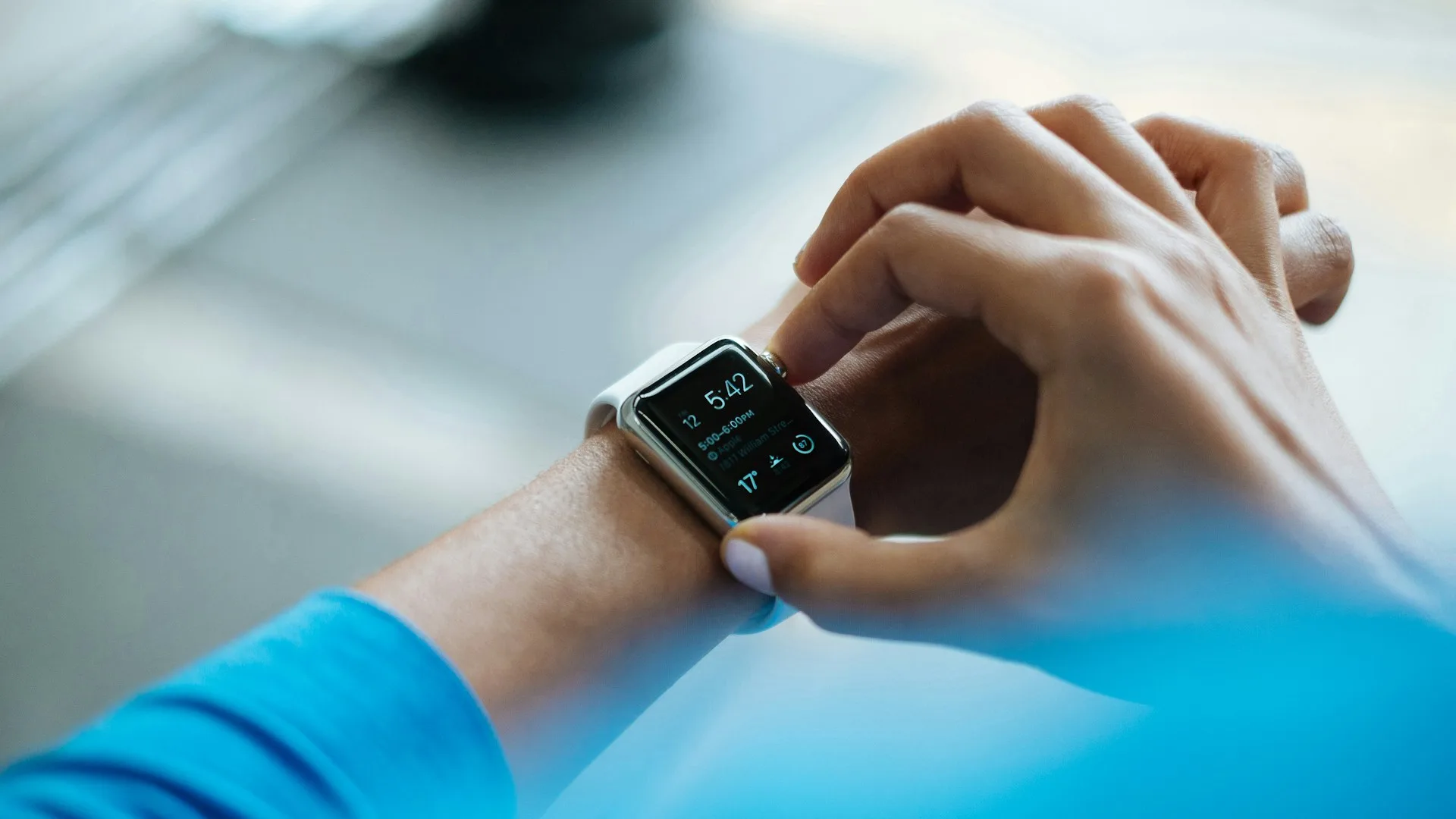 Close-up of an Apple Watch on a wrist, screen illuminated