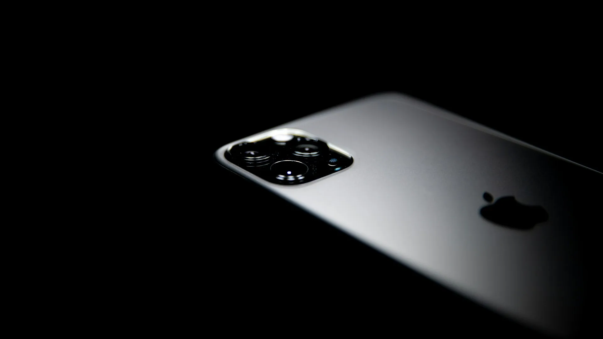 Black iPhone Pro Max on a dark background, hero product shot